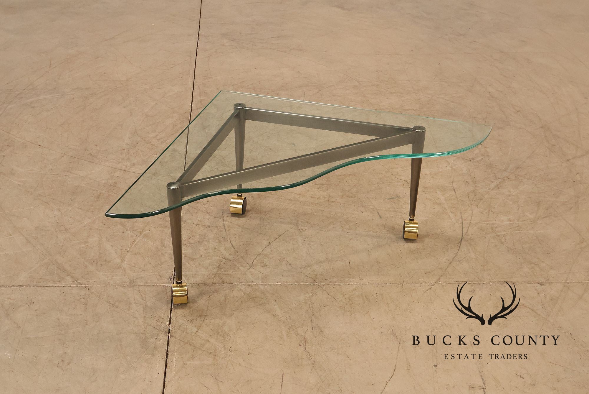 Postmodern Pair Of Triangular Glass Top Coffee Table with Brushed Steel Frame and Brass Casters