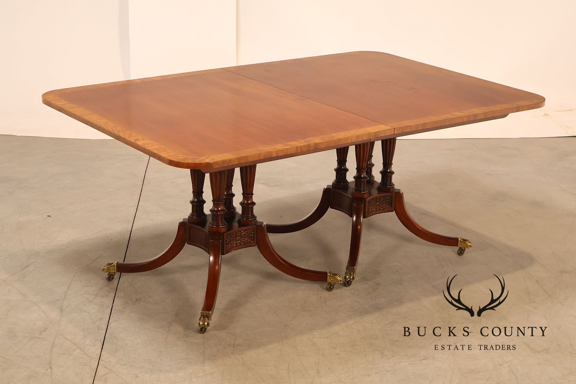 Baker Furniture Company Regency Style Mahogany Double Pedestal Dining Table With Satinwood Banding And Extension Leaves