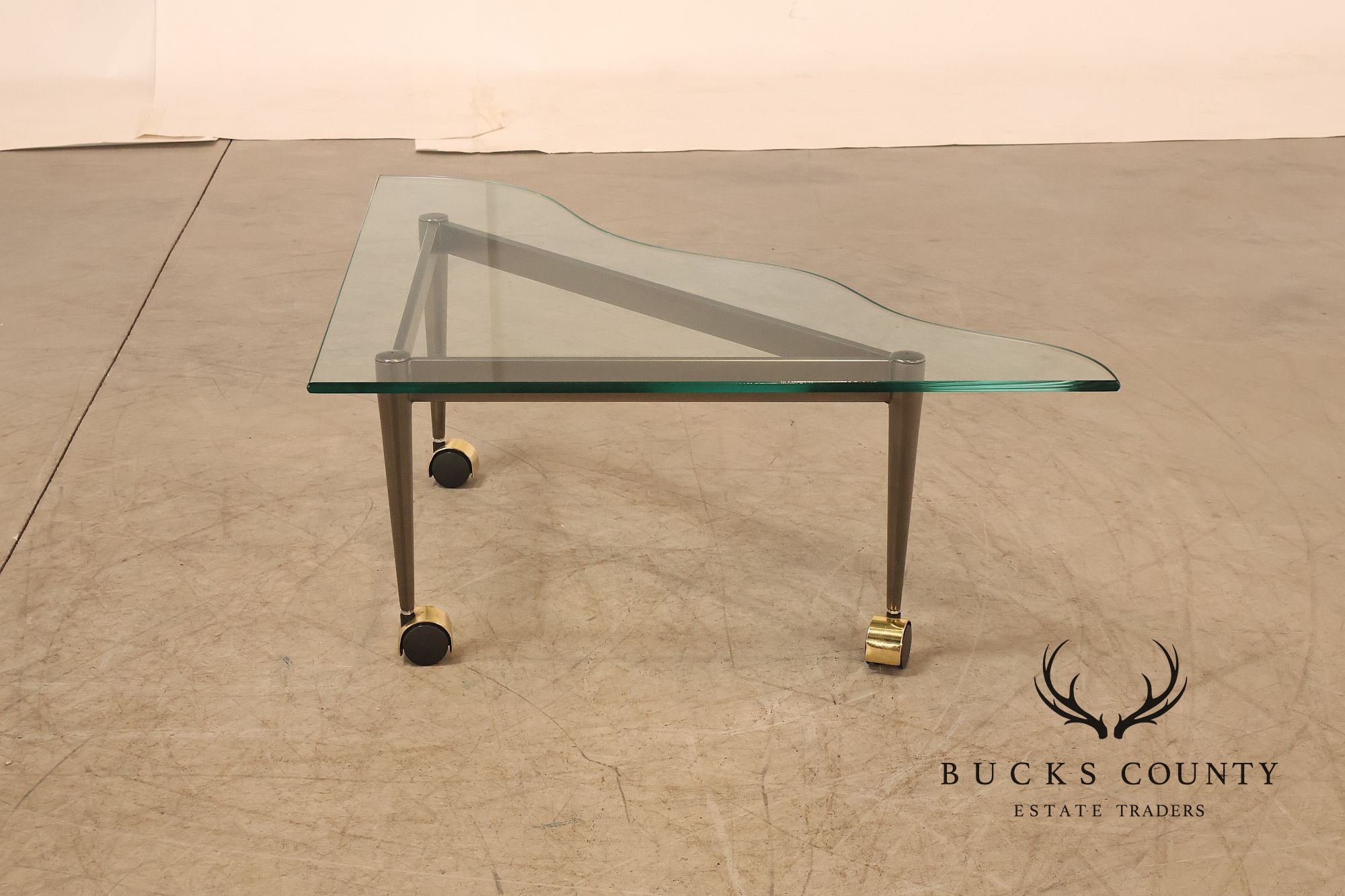 Postmodern Pair Of Triangular Glass Top Coffee Table with Brushed Steel Frame and Brass Casters