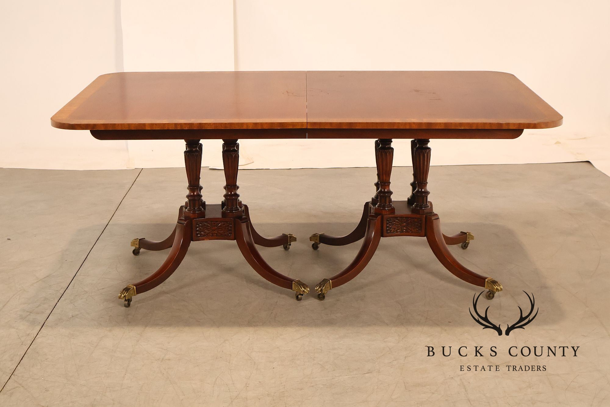 Baker Furniture Company Regency Style Mahogany Double Pedestal Dining Table With Satinwood Banding And Extension Leaves