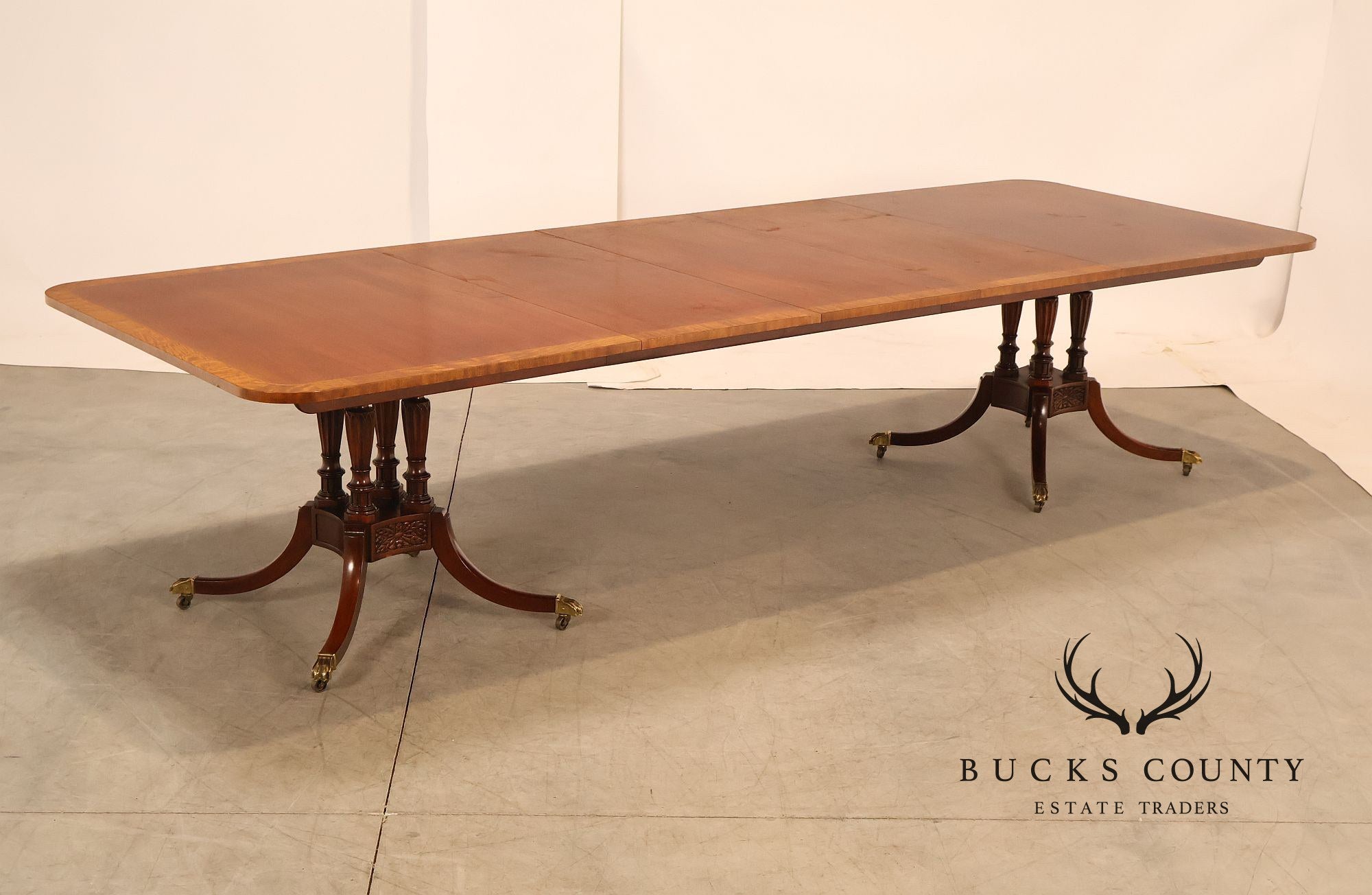Baker Furniture Company Regency Style Mahogany Double Pedestal Dining Table With Satinwood Banding And Extension Leaves