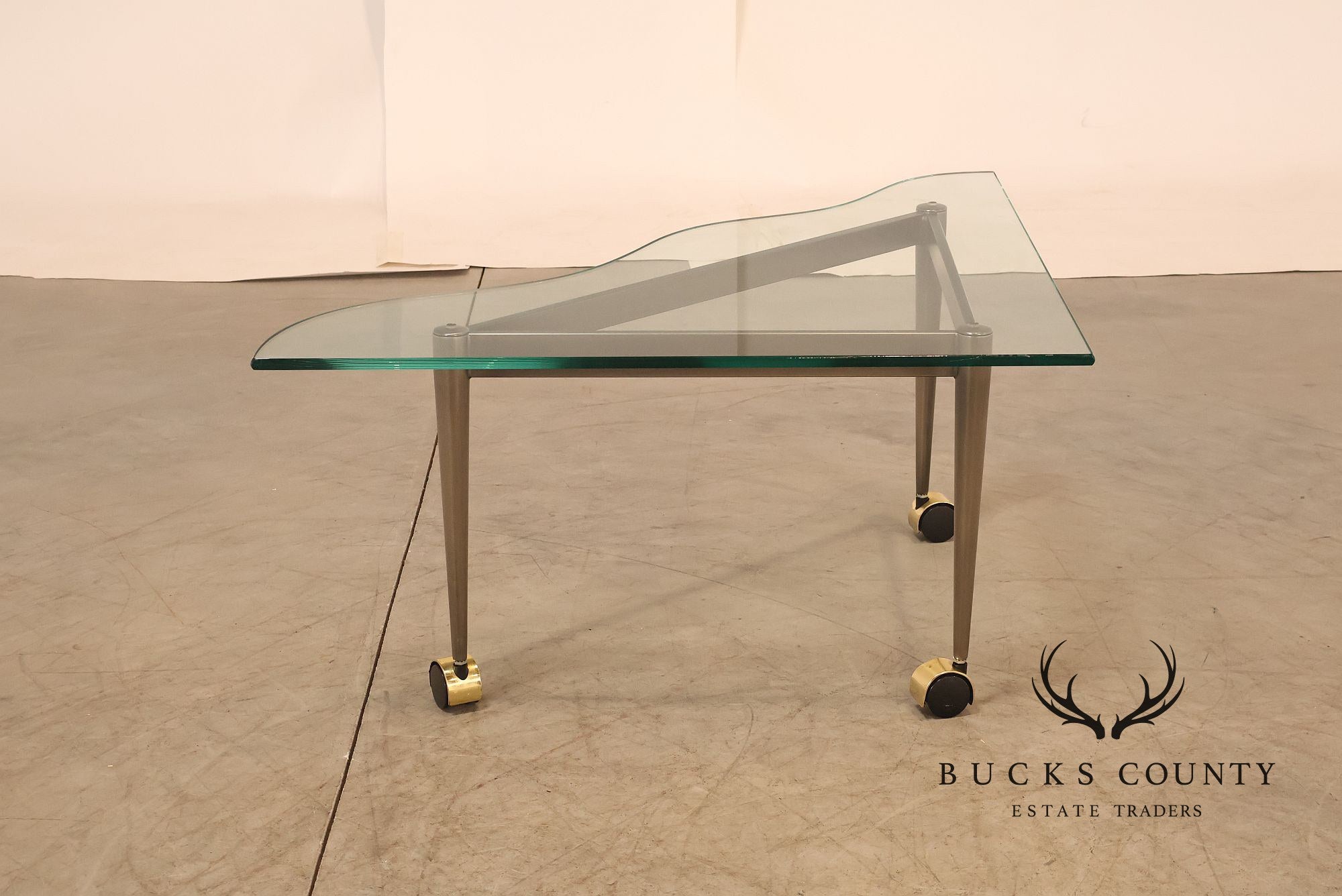 Postmodern Pair Of Triangular Glass Top Coffee Table with Brushed Steel Frame and Brass Casters