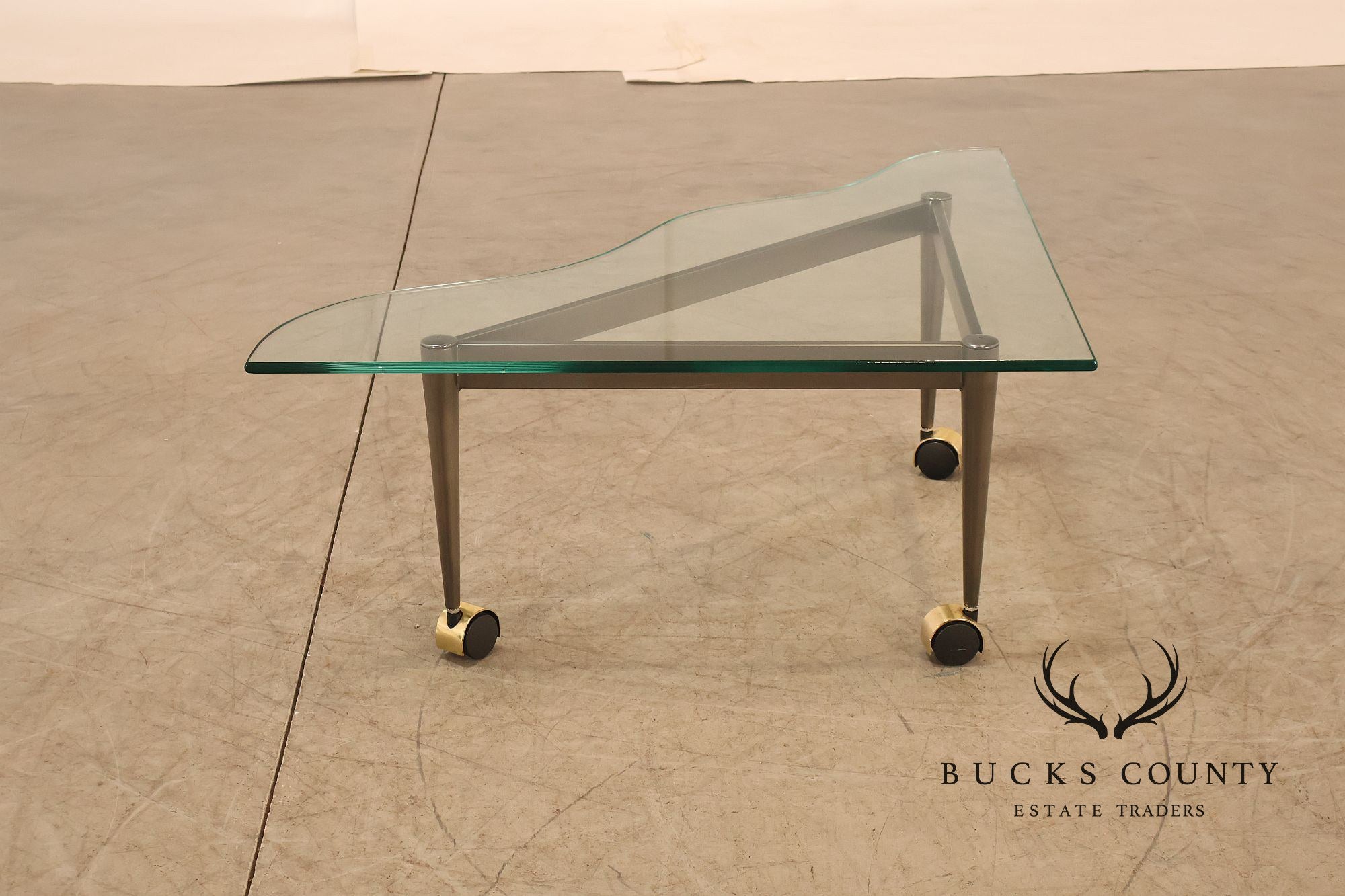 Postmodern Pair Of Triangular Glass Top Coffee Table with Brushed Steel Frame and Brass Casters
