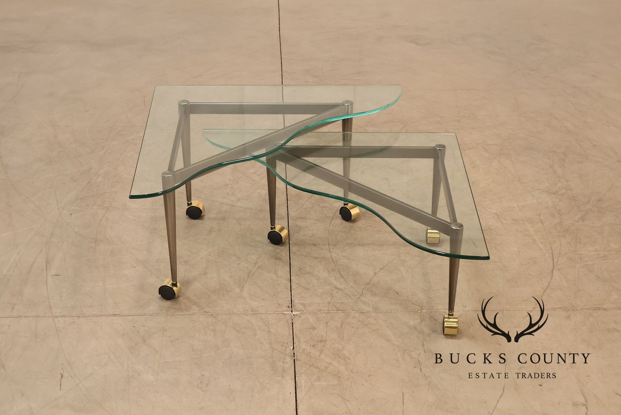 Postmodern Pair Of Triangular Glass Top Coffee Table with Brushed Steel Frame and Brass Casters