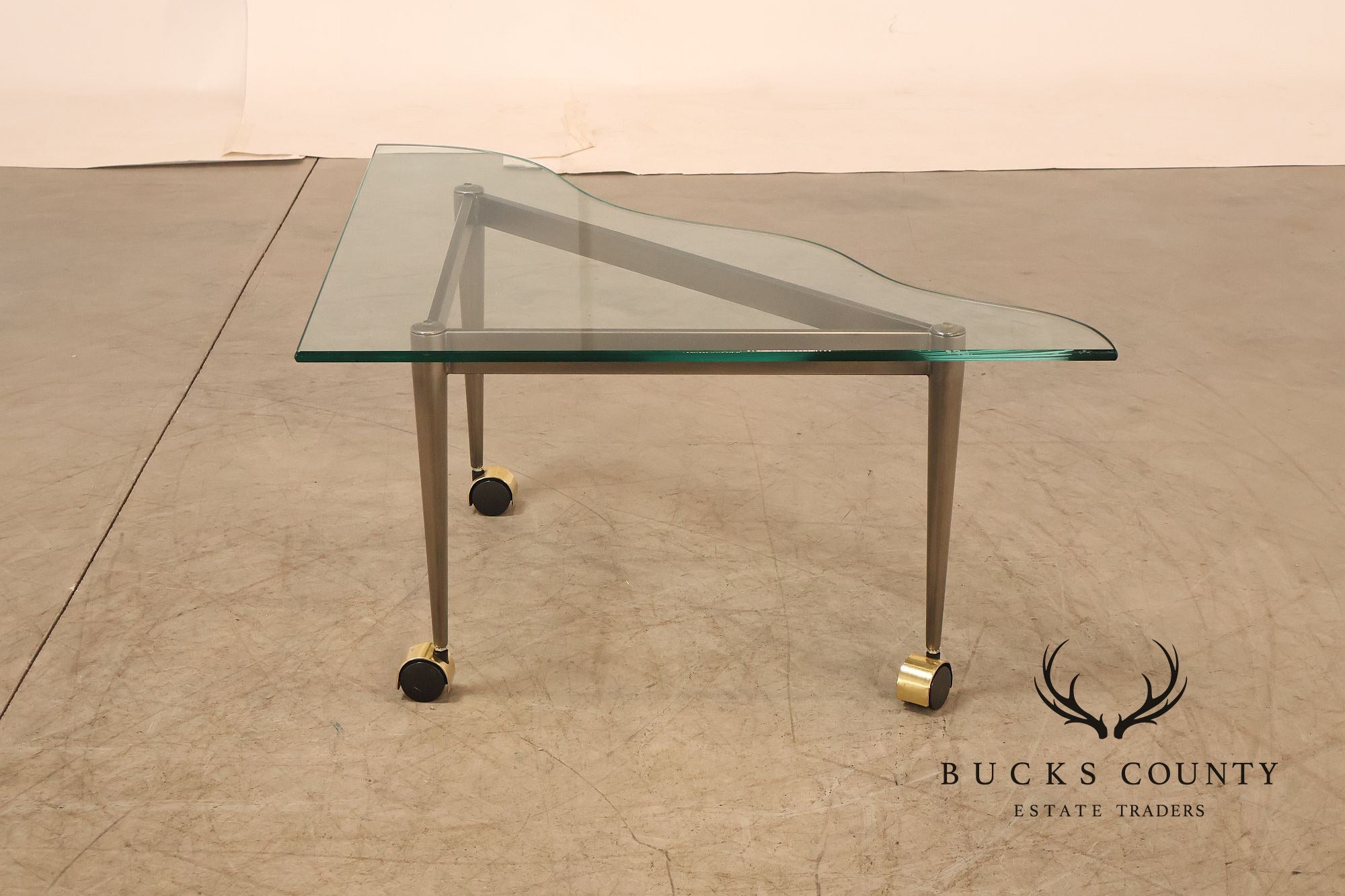 Postmodern Pair Of Triangular Glass Top Coffee Table with Brushed Steel Frame and Brass Casters