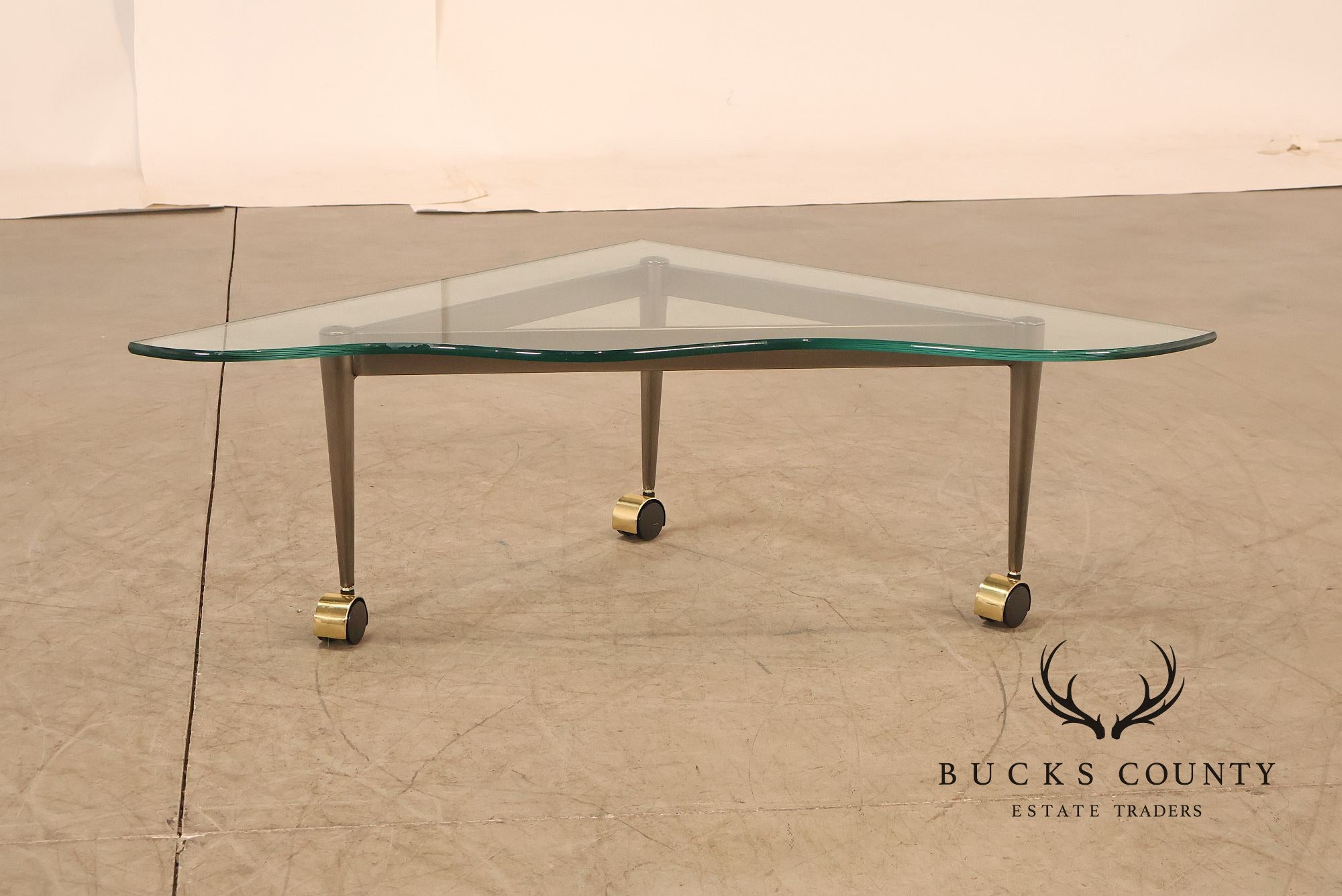 Postmodern Pair Of Triangular Glass Top Coffee Table with Brushed Steel Frame and Brass Casters