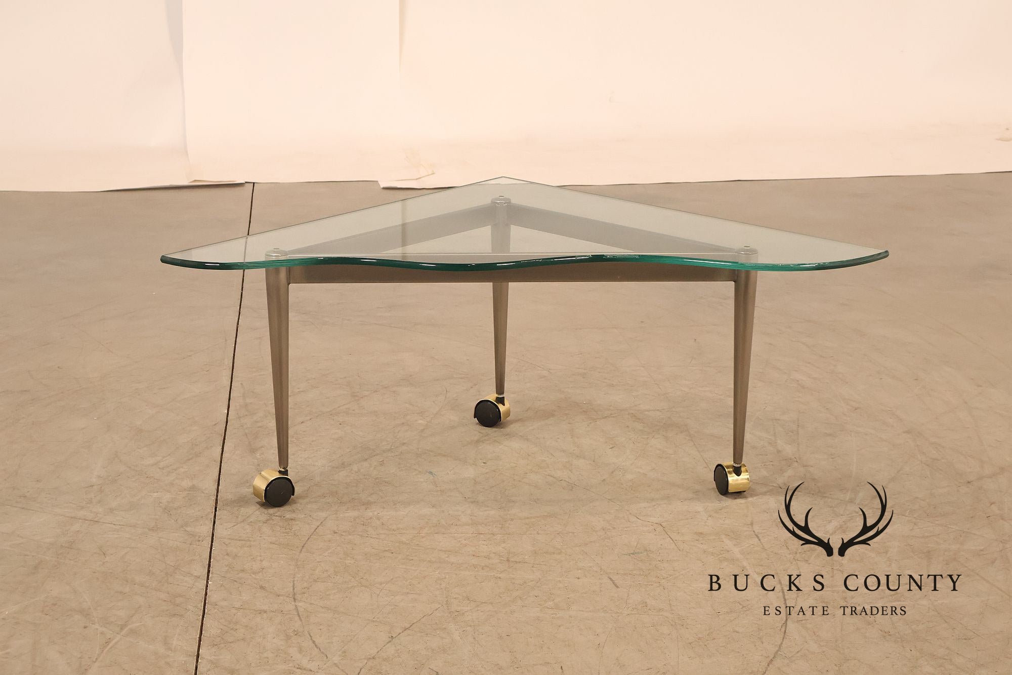 Postmodern Pair Of Triangular Glass Top Coffee Table with Brushed Steel Frame and Brass Casters