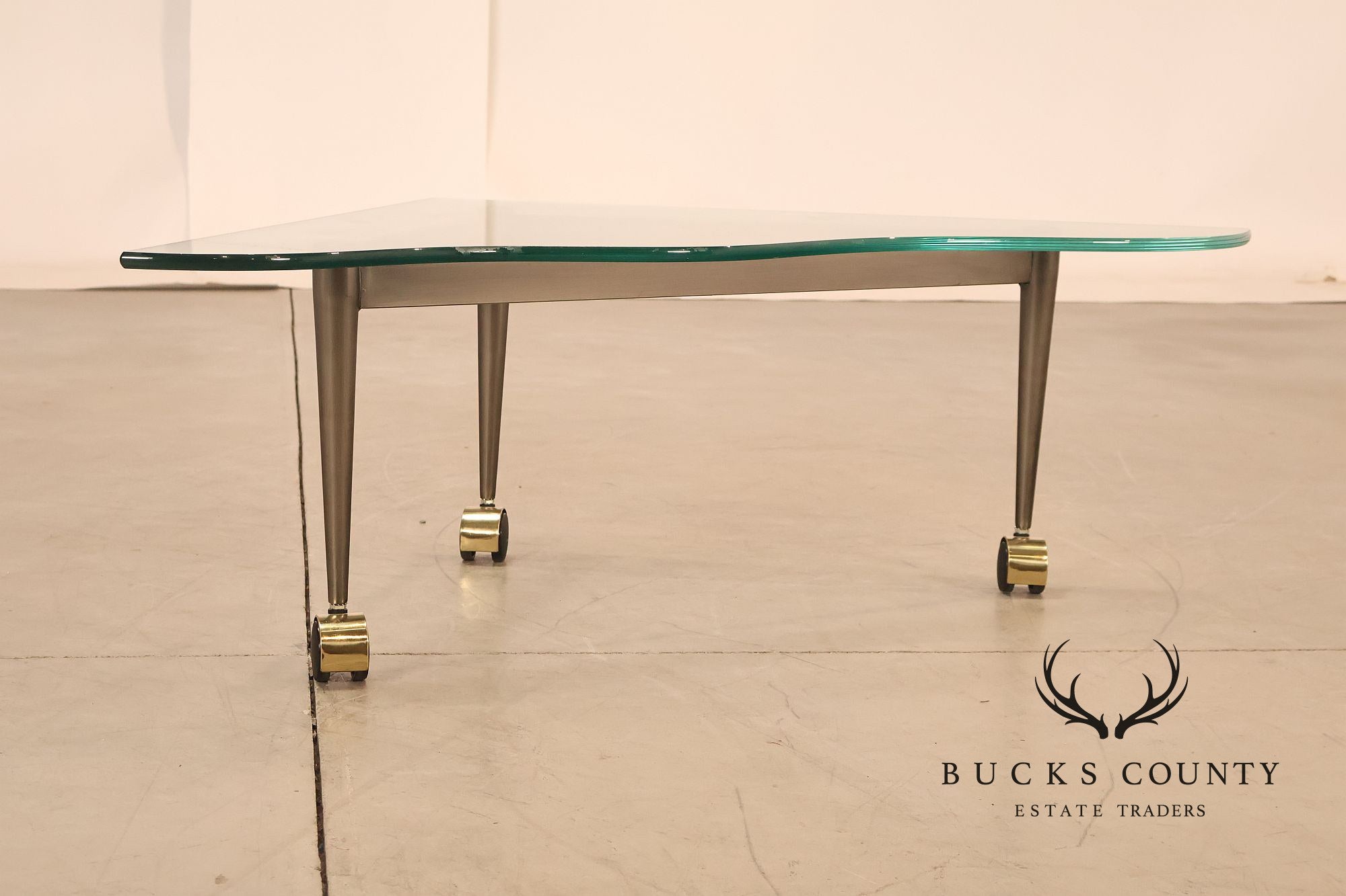 Postmodern Pair Of Triangular Glass Top Coffee Table with Brushed Steel Frame and Brass Casters