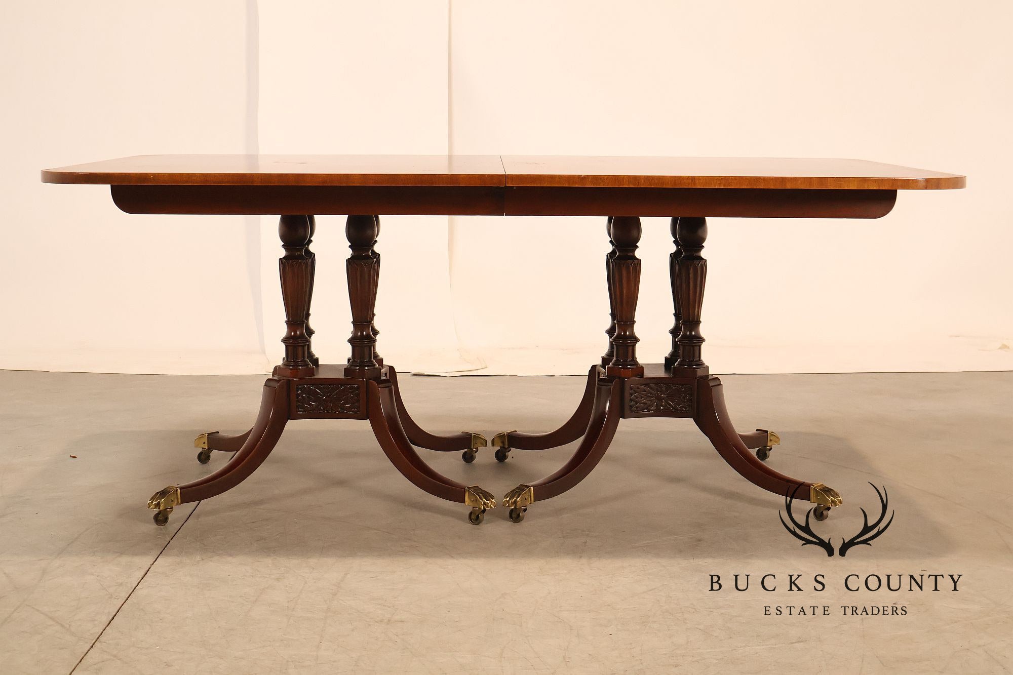 Baker Furniture Company Regency Style Mahogany Double Pedestal Dining Table With Satinwood Banding And Extension Leaves