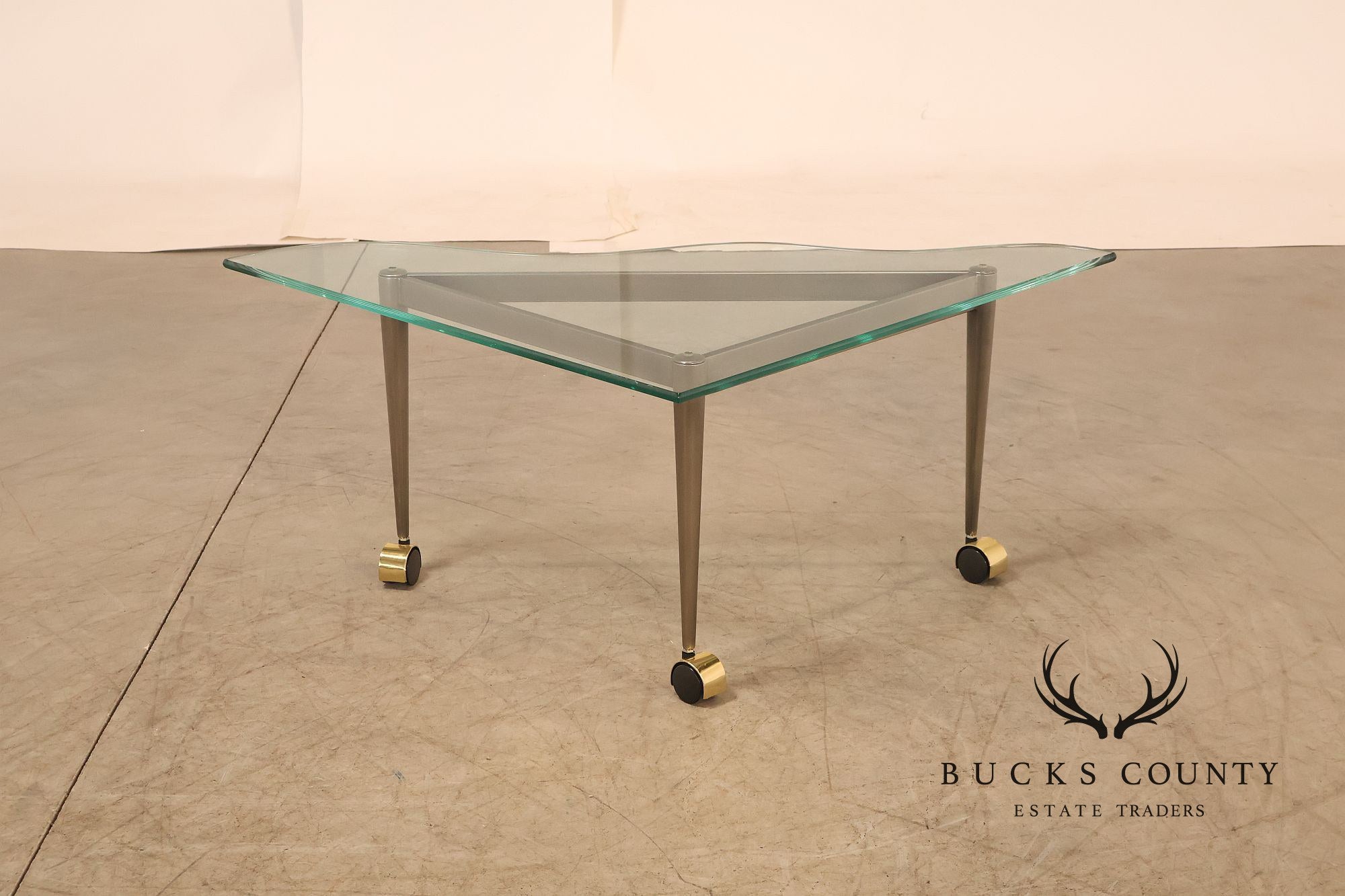 Postmodern Pair Of Triangular Glass Top Coffee Table with Brushed Steel Frame and Brass Casters