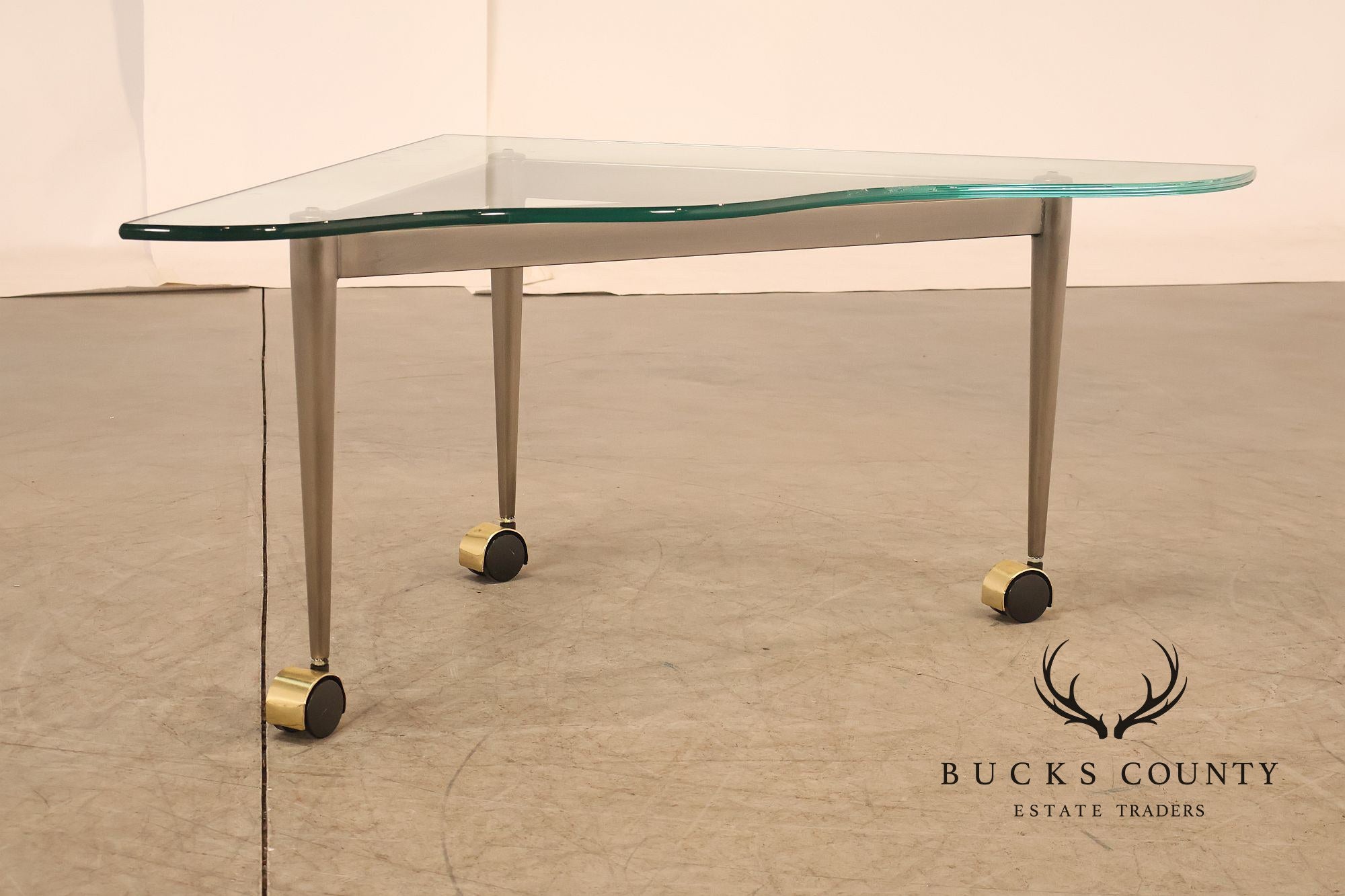 Postmodern Pair Of Triangular Glass Top Coffee Table with Brushed Steel Frame and Brass Casters