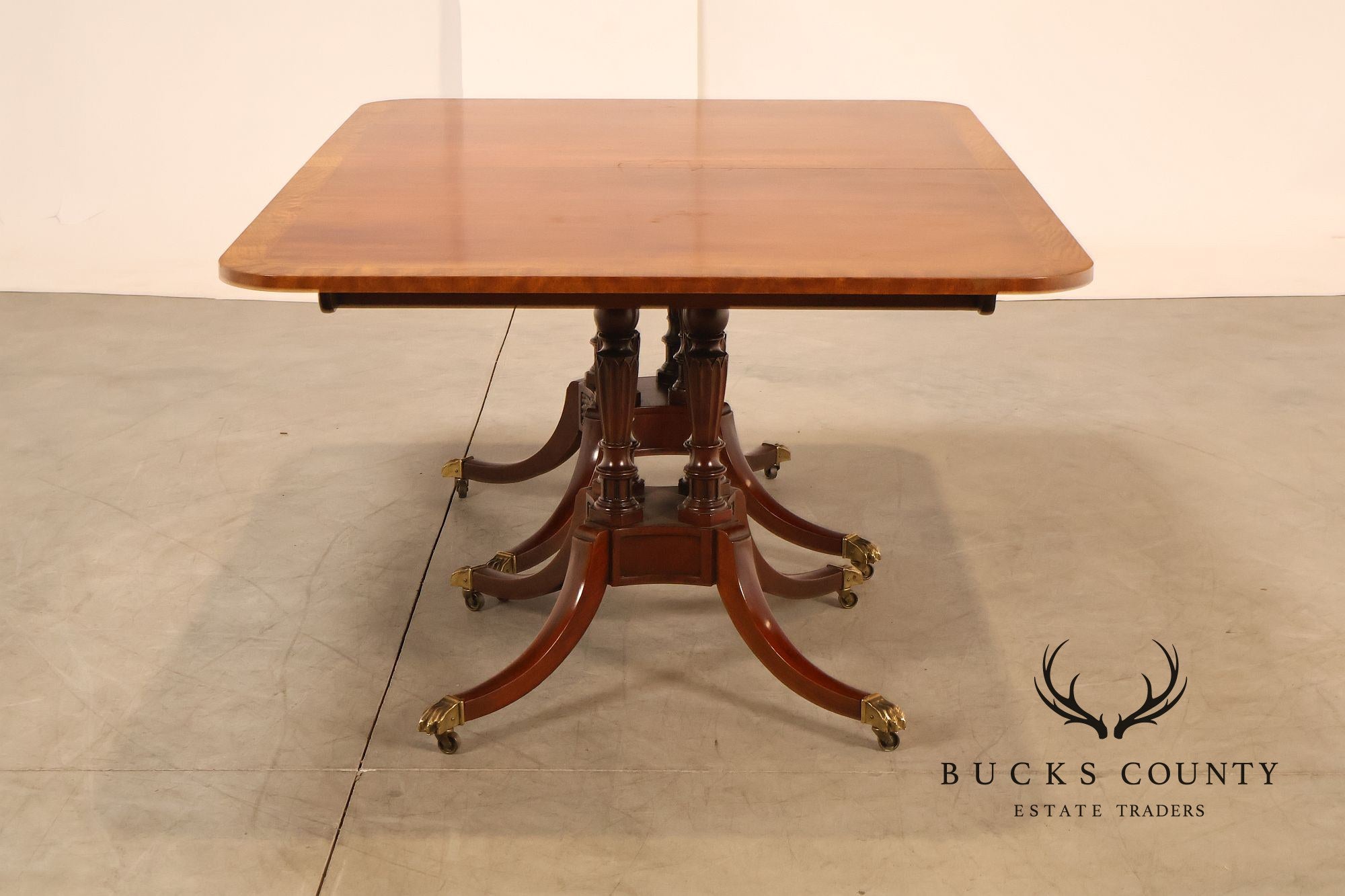 Baker Furniture Company Regency Style Mahogany Double Pedestal Dining Table With Satinwood Banding And Extension Leaves
