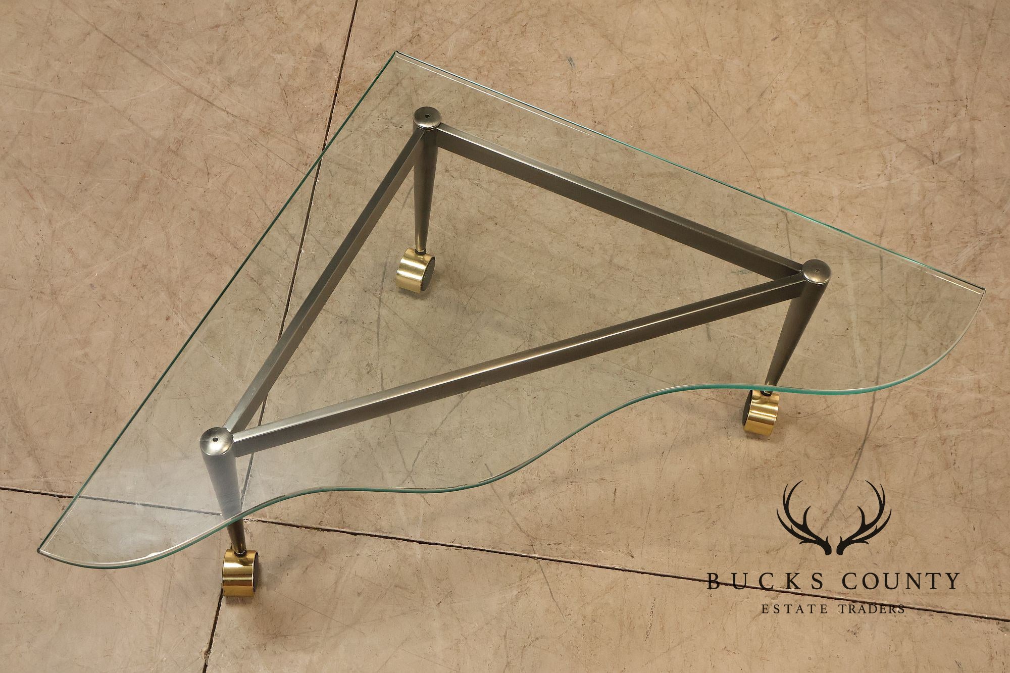 Postmodern Pair Of Triangular Glass Top Coffee Table with Brushed Steel Frame and Brass Casters