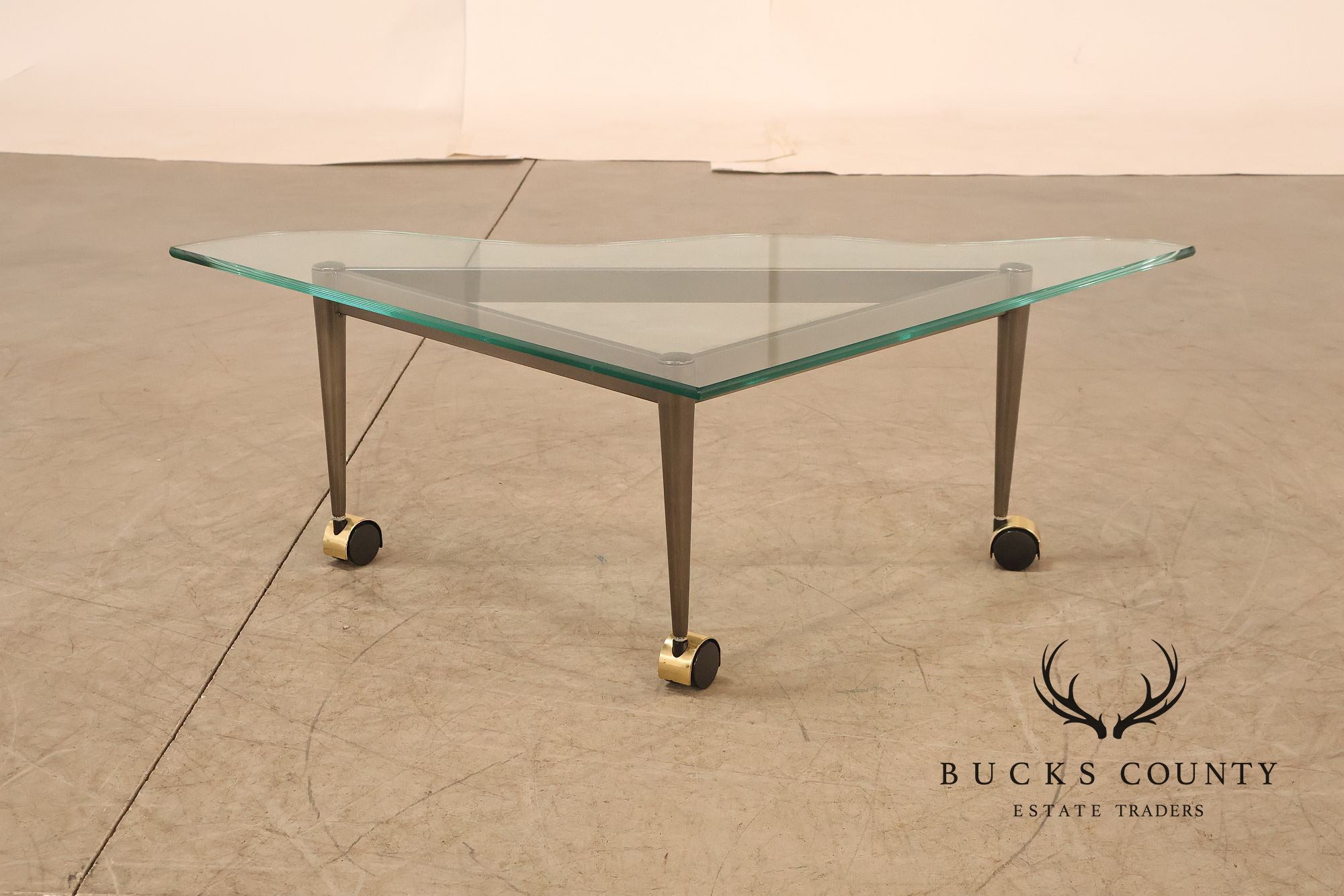 Postmodern Pair Of Triangular Glass Top Coffee Table with Brushed Steel Frame and Brass Casters