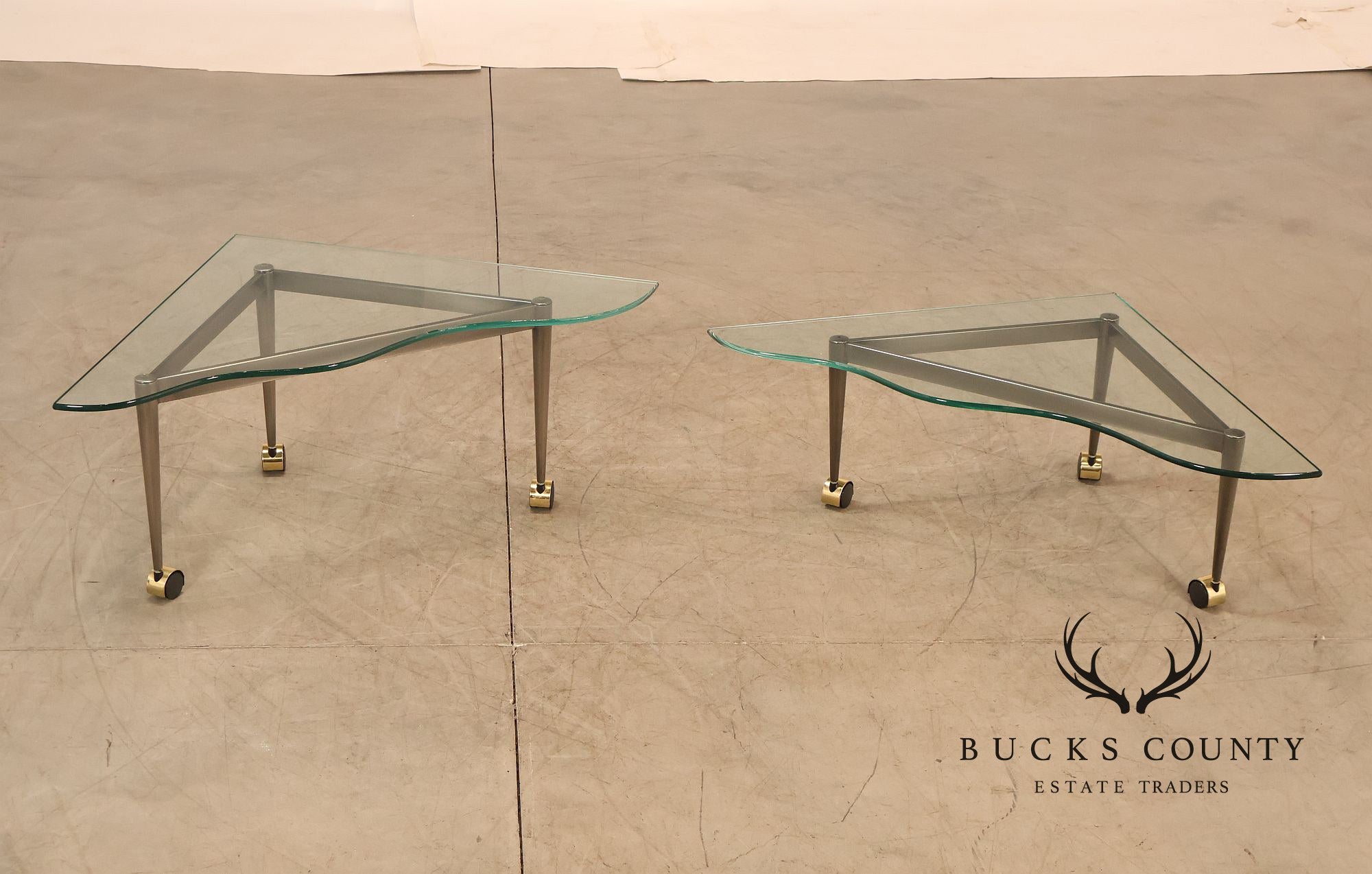 Postmodern Pair Of Triangular Glass Top Coffee Table with Brushed Steel Frame and Brass Casters