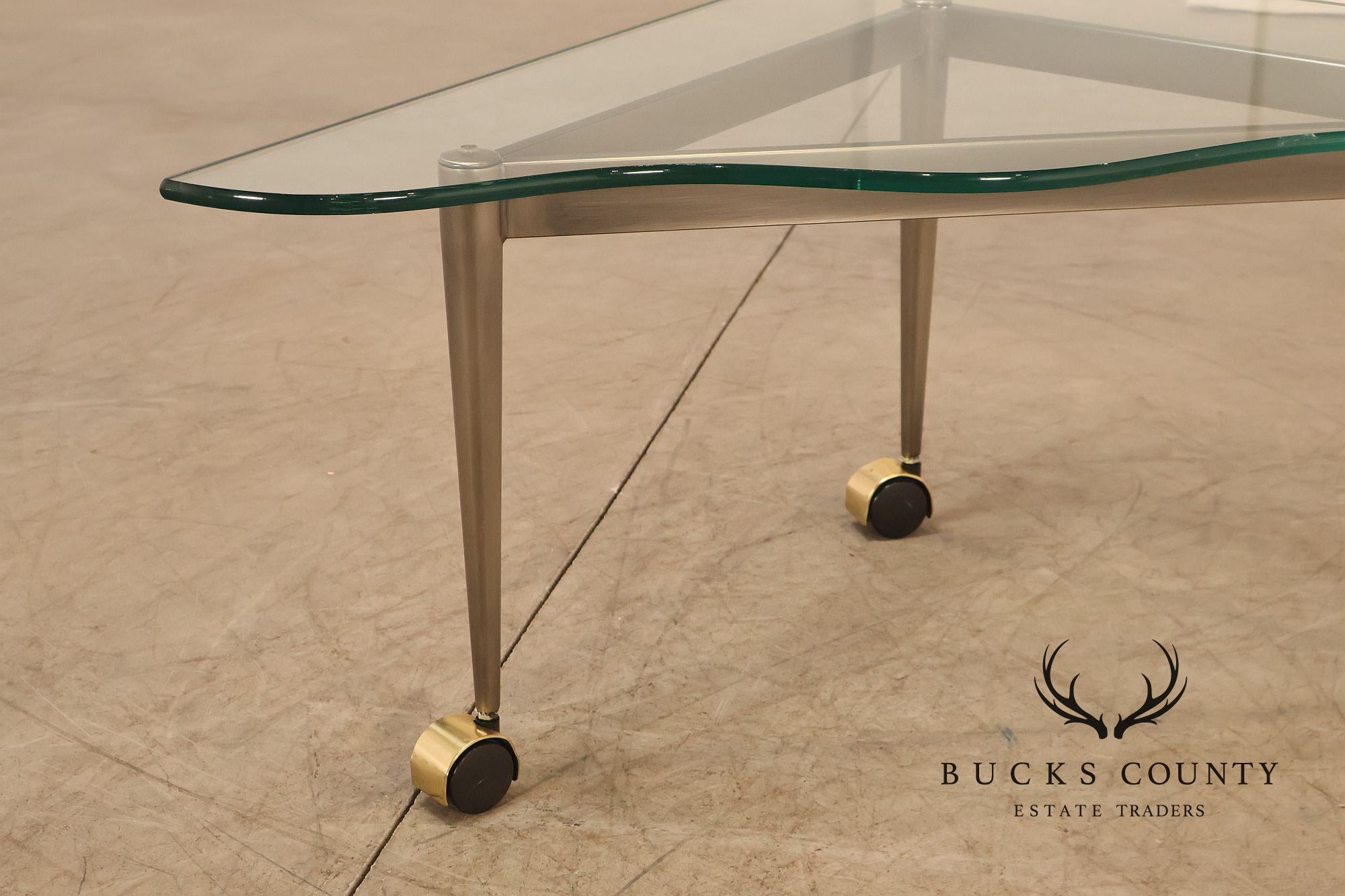 Postmodern Pair Of Triangular Glass Top Coffee Table with Brushed Steel Frame and Brass Casters