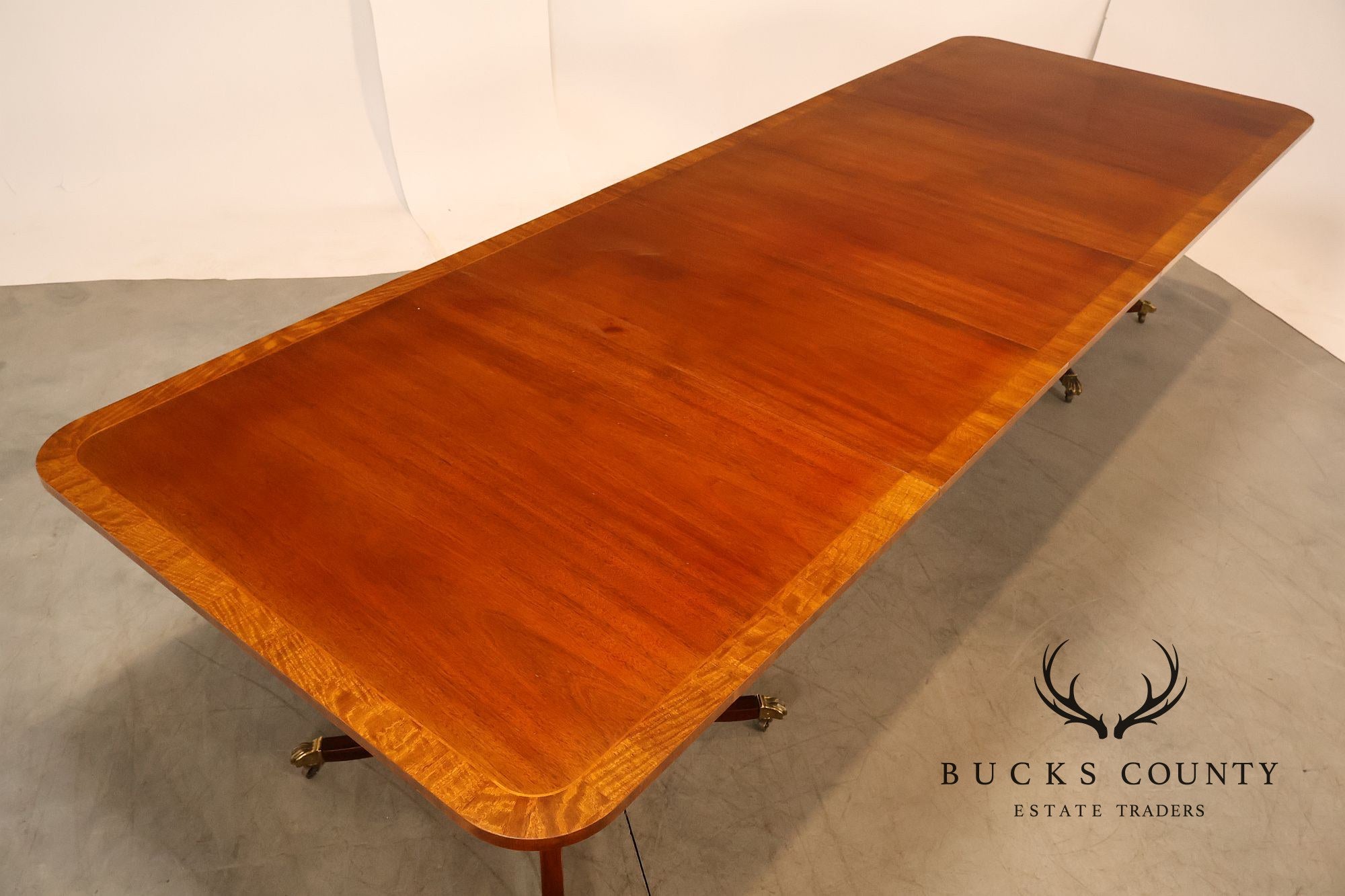 Baker Furniture Company Regency Style Mahogany Double Pedestal Dining Table With Satinwood Banding And Extension Leaves