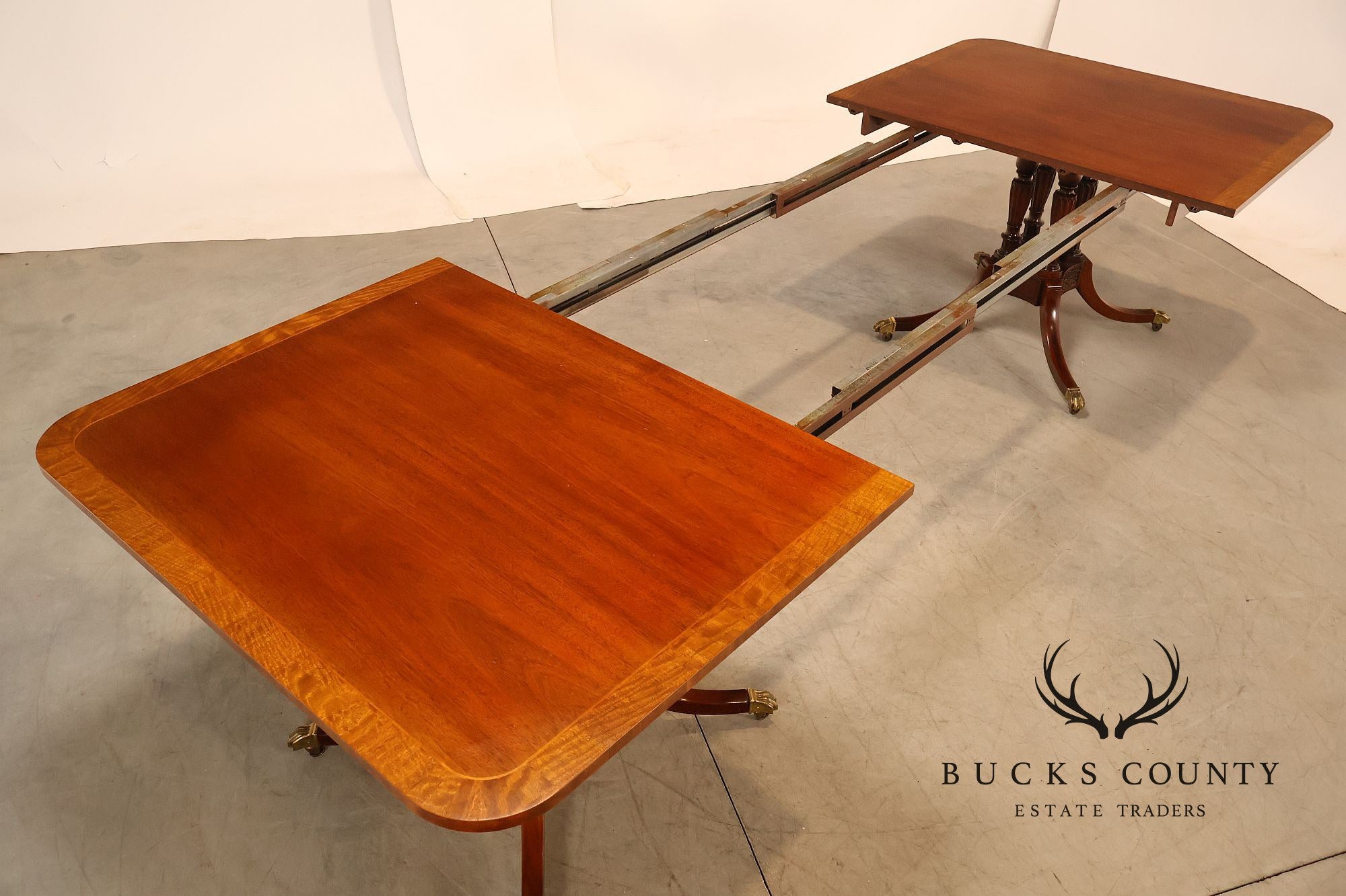 Baker Furniture Company Regency Style Mahogany Double Pedestal Dining Table With Satinwood Banding And Extension Leaves