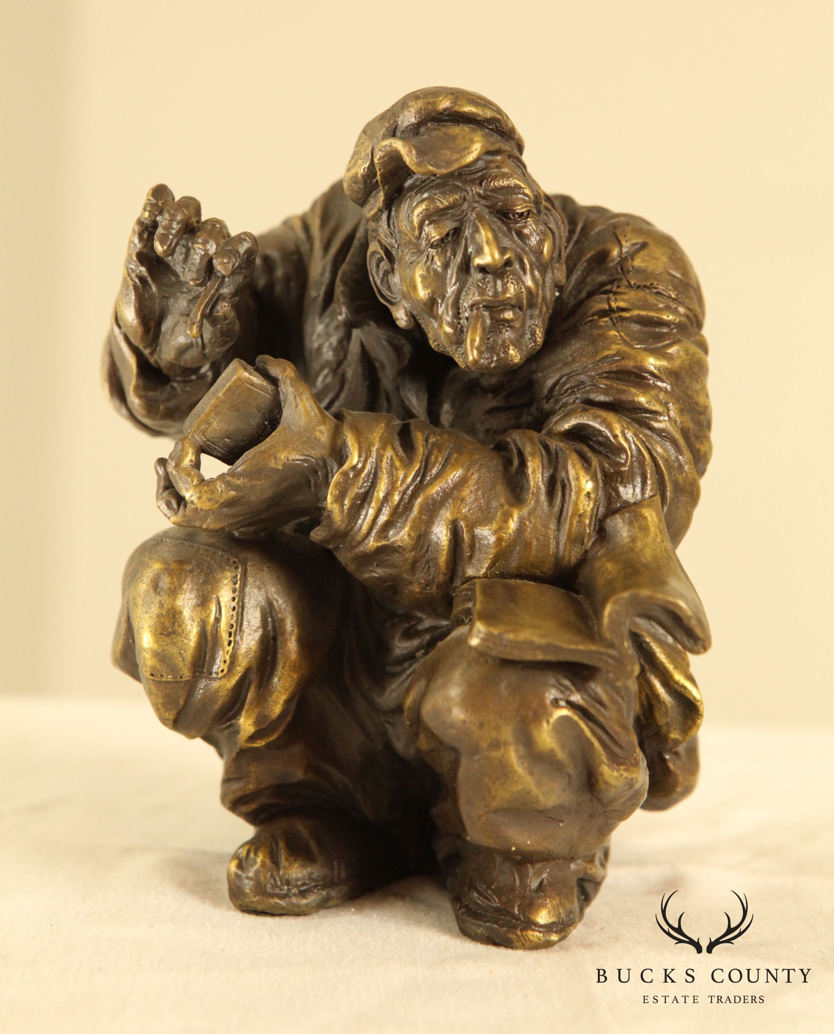 Atlie Bronze Figure of an Older Man Crouching, Reading, Striking Match