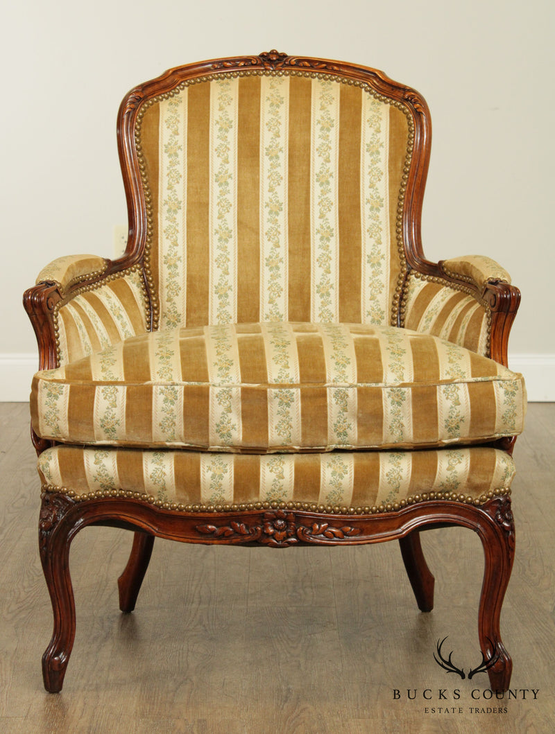 A nineteenth century, French upholstered Louis XV style bergere chair.