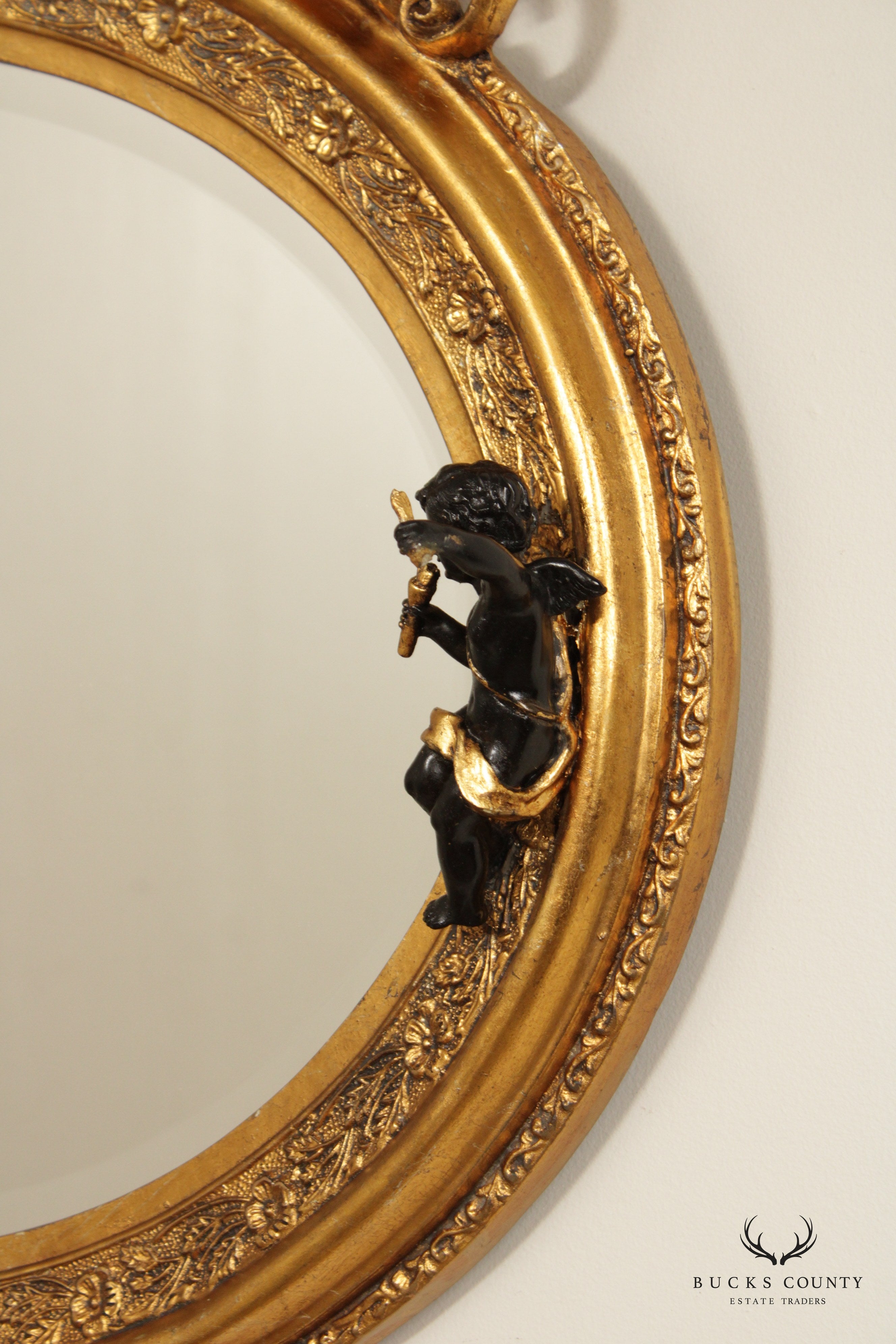 French Rococo Figural Ebonized and Gilted Oval Wall Mirror