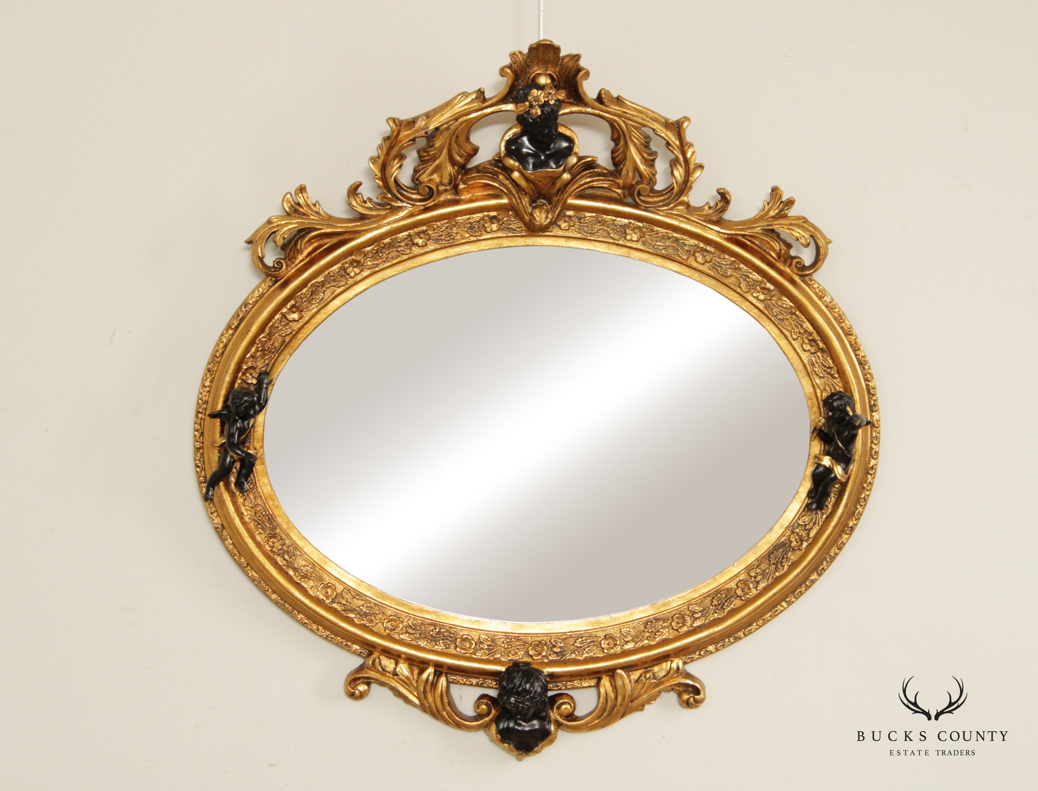 French Rococo Figural Ebonized and Gilted Oval Wall Mirror