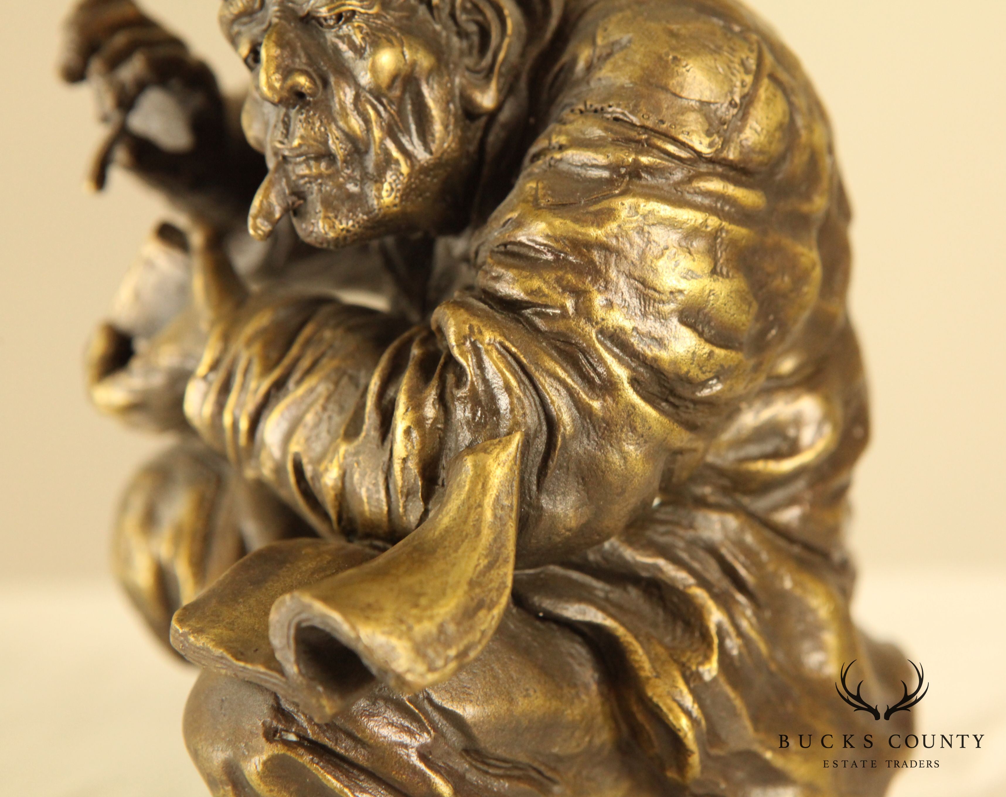 Atlie Bronze Figure of an Older Man Crouching, Reading, Striking Match