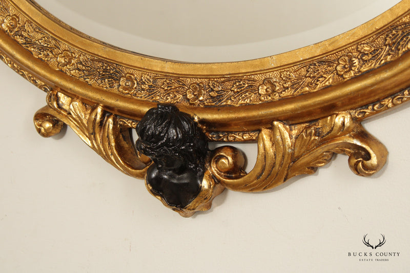 French Rococo Figural Ebonized and Gilted Oval Wall Mirror