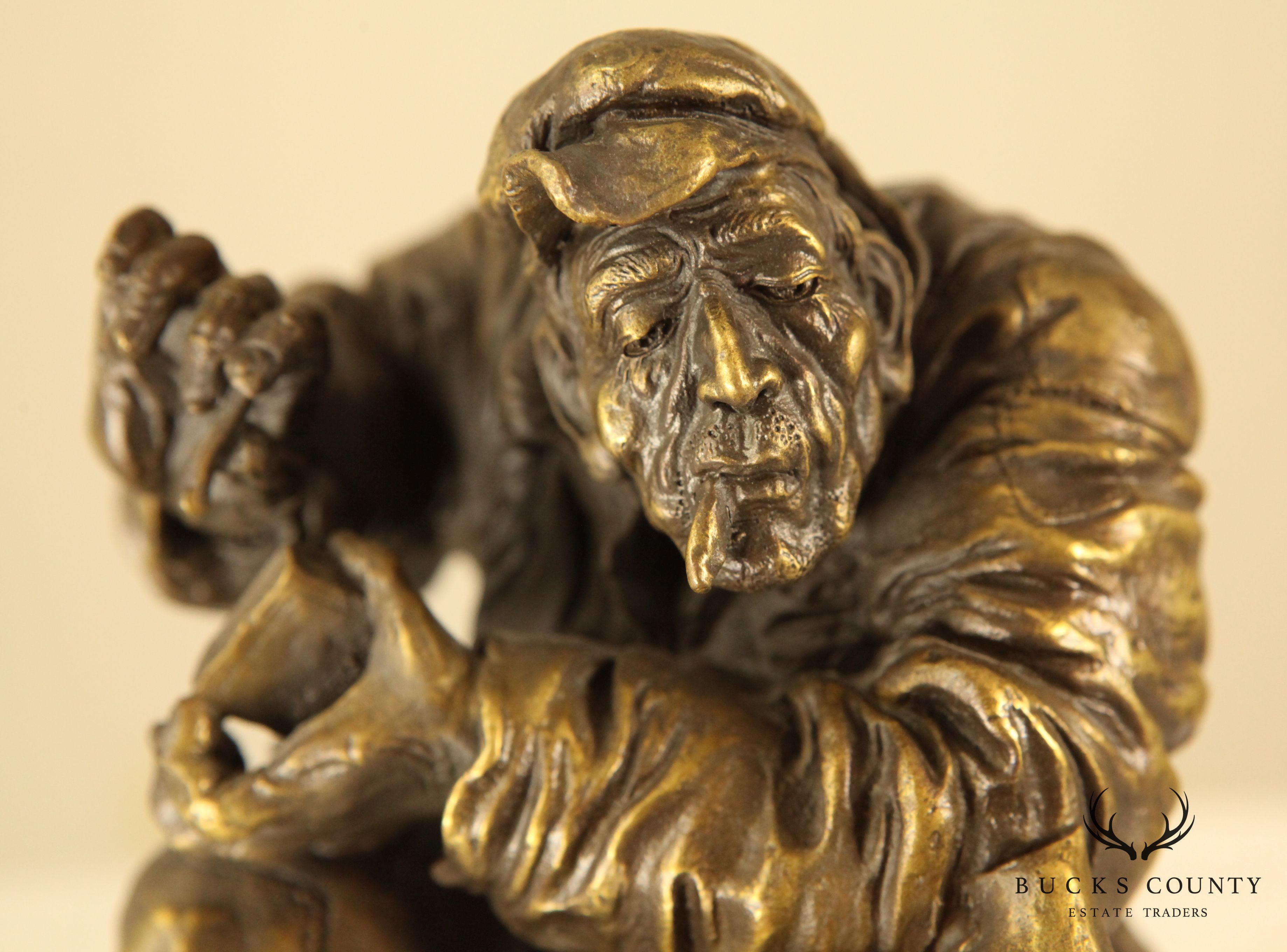 Atlie Bronze Figure of an Older Man Crouching, Reading, Striking Match