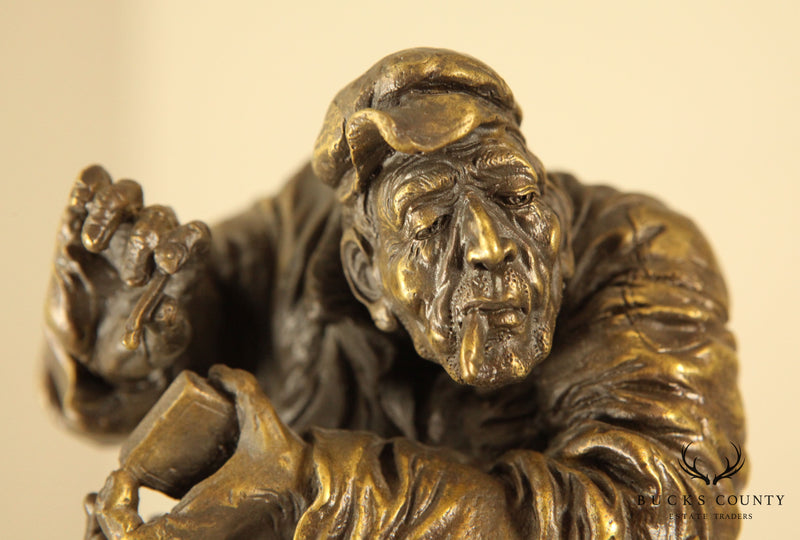 Atlie Bronze Figure of an Older Man Crouching, Reading, Striking Match