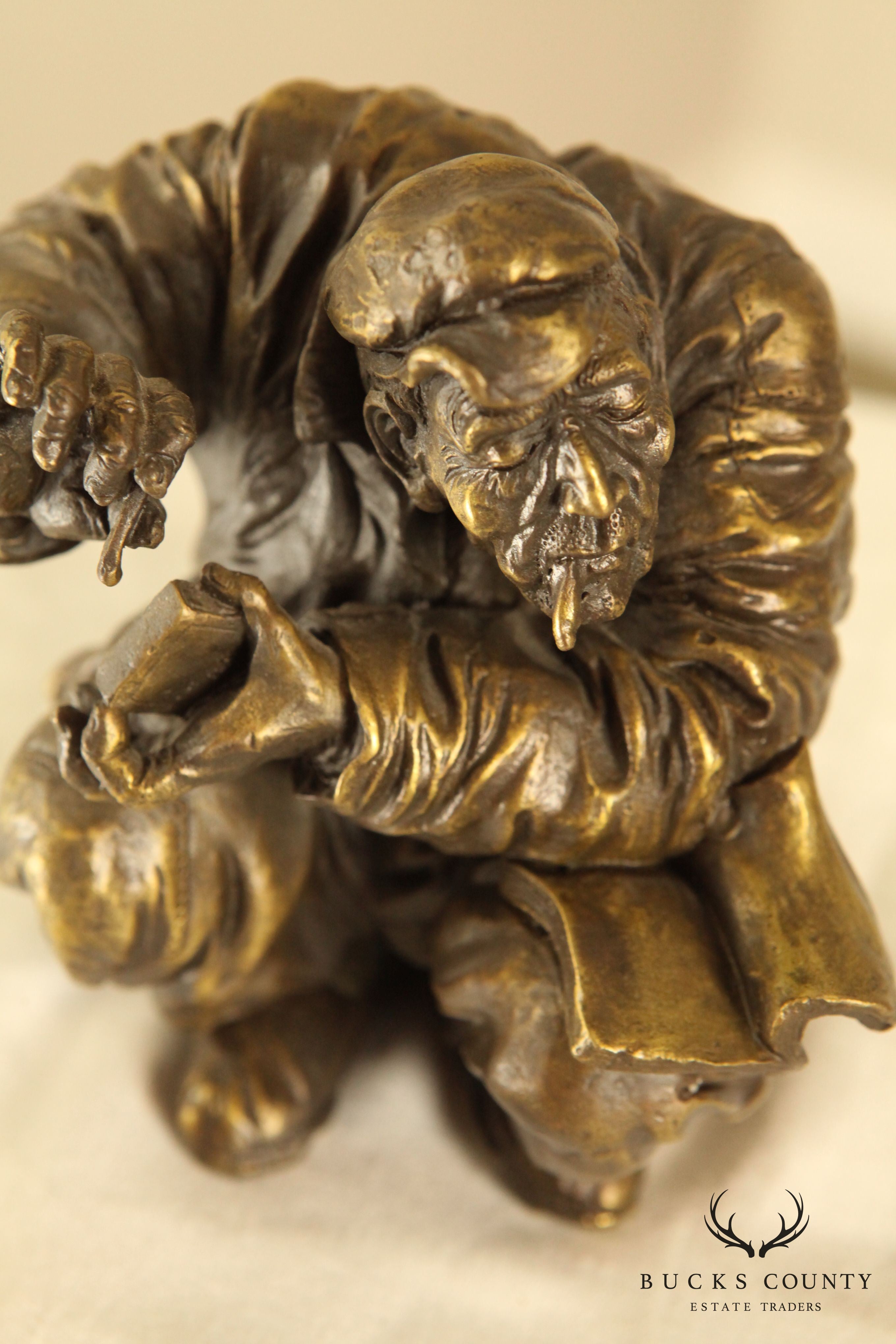 Atlie Bronze Figure of an Older Man Crouching, Reading, Striking Match