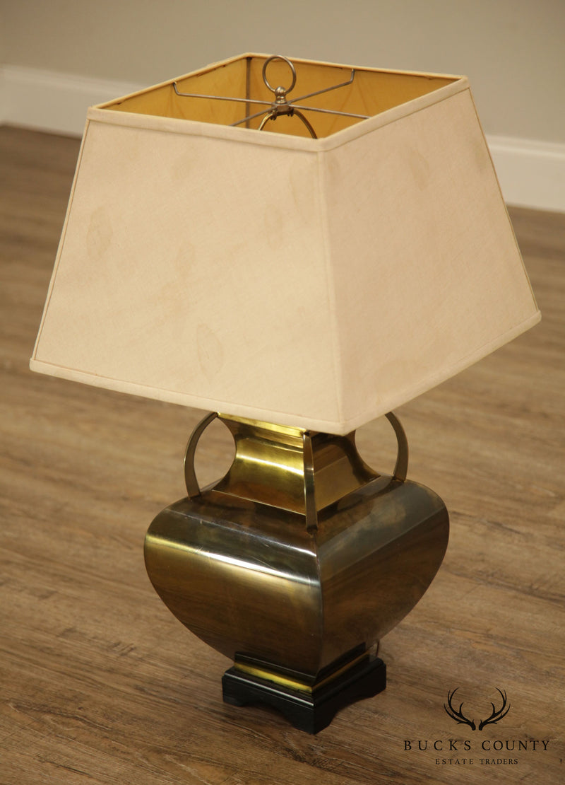A small sized table lamp with a square base in antique brass